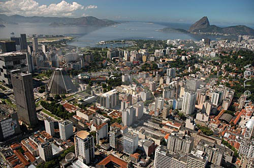  Aerial view of Rio de Janeiro city downtown, showing the conical Sao Sebastiao do Rio de Janeiro`s Cathedral (or Metropolitan Cathedral), the Petrobras Building (in cubes behind the cathedral) and the BNDES building to the left, the 
