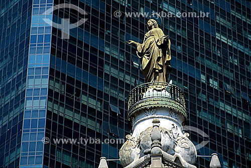  The statue of Our Lady of Conceiçao on top of the tower of the Our Lady of Carmo Church (*)  with a modern  building in the background -  Rio de Janeiro city  downtown - Rio de Janeiro state - Brazil  (*) This church has been renovated several times 