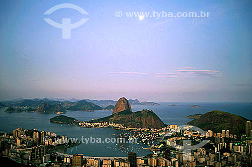  Aerial view of Sugar Loaf Mountain* with Botafogo Cove in the foreground and the moon high in the background - Rio de Janeiro city - Rio de Janeiro state - Brazil  *Commonly called Sugar Loaf Mountain, the entire rock formation also includes Urca Mo 