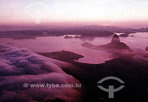  Panoramic view of the entrance to Guanabara Bay at dawn, with the silhouette of Sugar Loaf Mountain* in low clouds and Botafogo Cove in the foreground - Rio de Janeiro city - Rio de Janeiro state - Brazil  *Commonly called Sugar Loaf Mountain, the e 