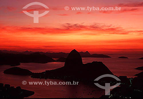  Silhouette of Sugar Loaf Mountain* at daybreak. - Rio de Janeiro city - Rio de Janeiro state - Brazil  *Commonly called Sugar Loaf Mountain, the entire rock formation also includes Urca Mountain and Sugar Loaf itself (the taller of the two). In this 