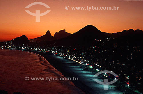  Copacabana Beach at sunset with Morro dos Dois Irmaos (Two Brothers Mountain) and Rock of Gavea in the background to the left - Rio de Janeiro city - Rio de Janeiro state - Brazil 