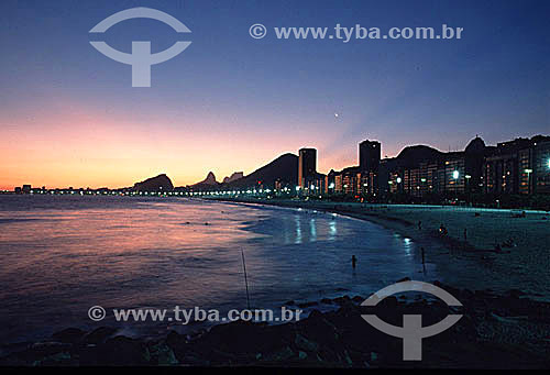  Copacabana Beach at sunset with Morro dos Dois Irmaos (Two Brothers Mountain) and Rock of Gavea in the background to the left - Rio de Janeiro city - Rio de Janeiro state - Brazil 