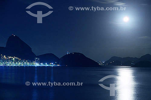  Detail of Sugar Loaf Mountain by night with the city lights of Copacabana Beach to the left and the moon high to the right - Copacabana - Rio de Janeiro city - Rio de Janeiro state - Brazil  
