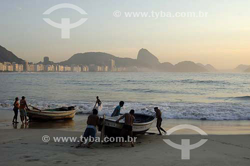  Copacabana Beach with Fishing boats and fishermen in the foreground and Suggar Loaf* in the background - Rio de Janeiro city - Rio de Janeiro state - Brazil - October 2006  *Commonly called Sugar Loaf Mountain, the entire rock formation also include 