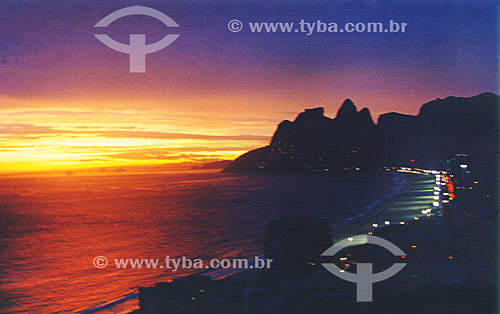  The sun sets on Ipanema Beach with Rock of Gavea and Morro Dois Irmaos (Two Brothers Mountain)* in the background - Rio de Janeiro city - RJ state - Brazil  * The Gavea Rock and the Two Brothers Mountain are National Historic Sites since 08-08-1973. 