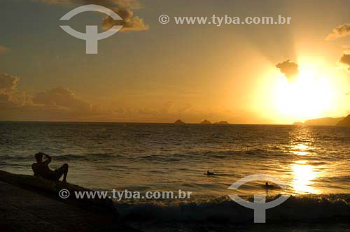  Man lying down looking the sunset at Ipanema Beach - Rio de Janeiro city - Rio de Janeiro state - Brazil 