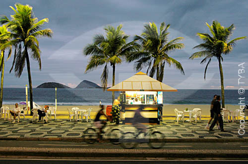  Cococnut trees and stand at Ipanema Beach with the people walking on the promenade - Rio de Janeiro city - Rio de Janeiro state - Brazil 