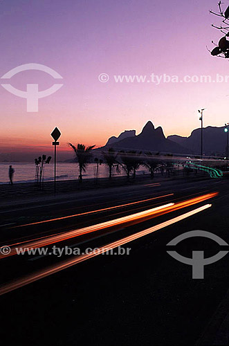  Sunset on Ipanema Beach with Rock of Gavea and Morro Dois Irmaos (Two Brothers Mountain)* in the background with the lights of cars moving in the foreground - Rio de Janeiro city - Rio de Janeiro state - Brazil  * The Gavea Rock and the Two Brothers 