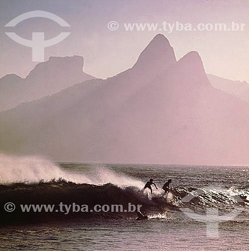  Surfers on Ipanema Beach with Rock of Gavea and the Morro Dois Irmaos (Two Brothers Mountain)* in the background - Rio de Janeiro city - Rio de Janeiro state - Brazil  * The Gavea Rock and the Two Brothers Mountain are National Historic Sites since  