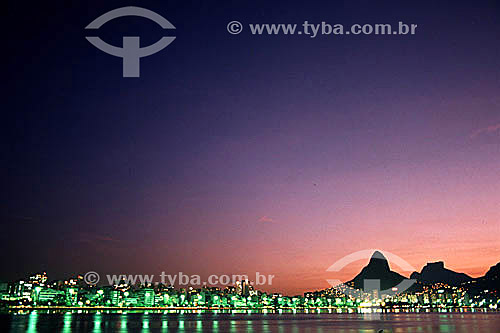  luminated buildings lining the shores of Lagoa Rodrigo de Freitas (Rodrigo de Freitas Lagoon) (1) at sunset, with Rock of Gavea and Morro Dois Irmaos (Two Brothers Mountain) (2) in the background to the right - Rio de Janeiro city - Rio de Janeiro s 