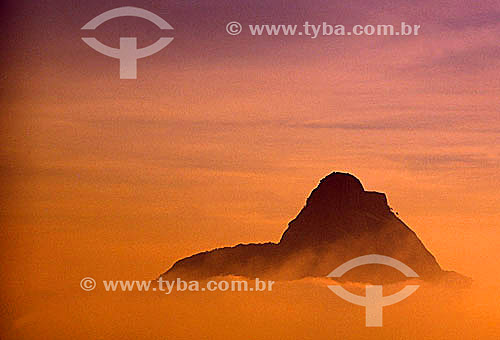  View of the peak of Rock of Gavea* extending above the clouds at sunset - Rio de Janeiro city - Rio de Janeiro state - Brazil  * The Rock of Gavea is a National Historic Site since 08-08-1973. 