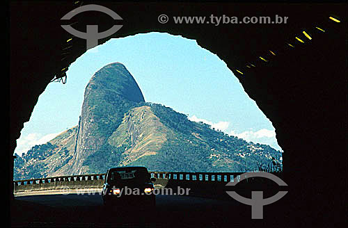  Car entering Elevado do Joa Tunnel with Morro Dois Irmaos (Two Brothers Mountain)* in the background - Rio de Janeiro city - Rio de Janeiro state - Brazil  * National Historic Site since 08-08-1973. 