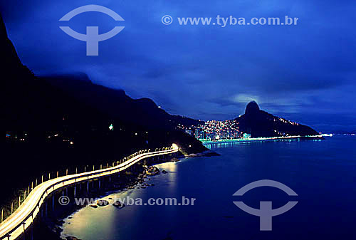  View of Elevado do Joa (Elevated Road of Joa) as illuminated by the lights of moving cars, with the lights of the neighborhood of Rocinha (once known as the largest slum in Latin America) and Morro Dois Irmaos (Two Brothers Mountain)  - Rio de Janeiro city - Rio de Janeiro state (RJ) - Brazil