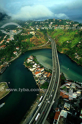  Aerial view of Elevado do Joá (Joa Elevated Road) over channel de Marapendi (Marapendi channel), at the beginning of Barra da Tijuca, with mansions on the hillside of Joatinga above the expressway - Rio de Janeiro state - Brazil 