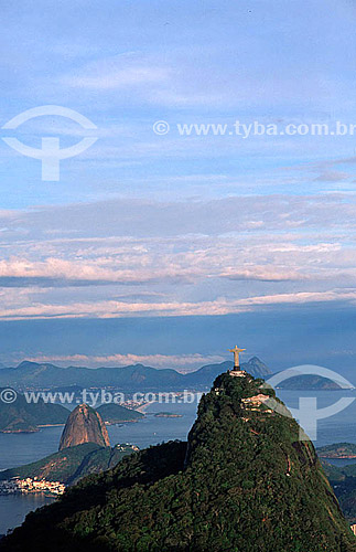  Aerial view of Cristo Redentor (Christ the Redeemer) with Sugar Loaf Mountain* just behind it, and the city of Niteroi in the background - Rio de Janeiro city - Rio de Janeiro state - Brazil  * Commonly called Sugar Loaf Mountain, the entire rock fo 