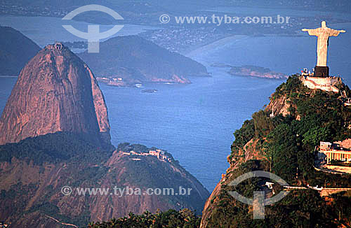  Aerial view of Cristo Redentor (Christ the Redeemer) with Sugar Loaf Mountain* to the left, and the city of Niteroi in the background - Rio de Janeiro city - Rio de Janeiro state - Brazil  * Commonly called Sugar Loaf Mountain, the entire rock forma 