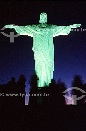 Silhouette of people standing in front of the brightly illuminated Cristo Redentor (Christ the Redeemer) at twilight - Rio de Janeiro city - Rio de Janeiro state - Brazil 
