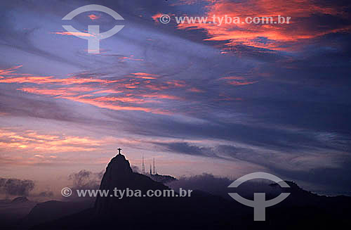  Silhouette of Cristo Redentor (Christ the Redeemer) on top of Morro do Corcovado (Corcovado Mountain) at dawn, with the radio transmission towers of Sumare in the background - Rio de Janeiro city - Rio de Janeiro state - Brazil 