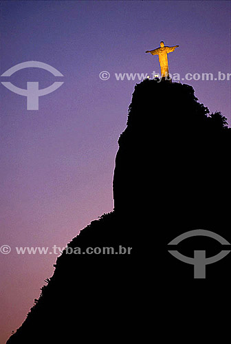  The brightly illuminated Cristo Redentor (Christ the Redeemer) on top of the silhouette of Morro do Corcovado (Corcovado Mountain) at twilight - Rio de Janeiro - Rio de Janeiro city - Rio de Janeiro state - Brazil 
