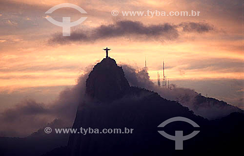  Silhouette of Cristo Redentor (Christ the Redeemer) on top of Morro do Corcovado (Corcovado Mountain) at dawn, with the radio transmission towers of Sumare in the background - Rio de Janeiro city - Rio de Janeiro state - Brazil 