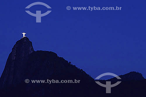  The brightly illuminated Cristo Redentor (Christ the Redeemer) on top of the silhouette of Morro do Corcovado (Corcovado Mountain) at night  - Rio de Janeiro city - Rio de Janeiro state (RJ) - Brazil