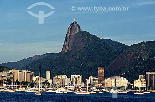  Cristo Redentor (Christ the Redeemer) at Morro do Corcovado (Corcovado Mountain) as seen from the neighborhood of Urca, with buildings on Botafogo Cove and boats on Guanabara Bay in the foreground - Rio de Janeiro city - Rio de Janeiro state - Brazi 