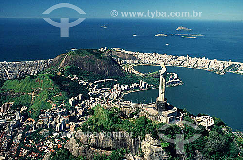  Aerial view of Cristo Redentor (Christ the Redeemer), with part of Lagoa Rodrigo de Freitas (Rodrigo de Freitas Lagoon)* to the right and the buildings of the neighborhood of Ipanema behind it, buildings of the neighborhood of Copacabana to the left 