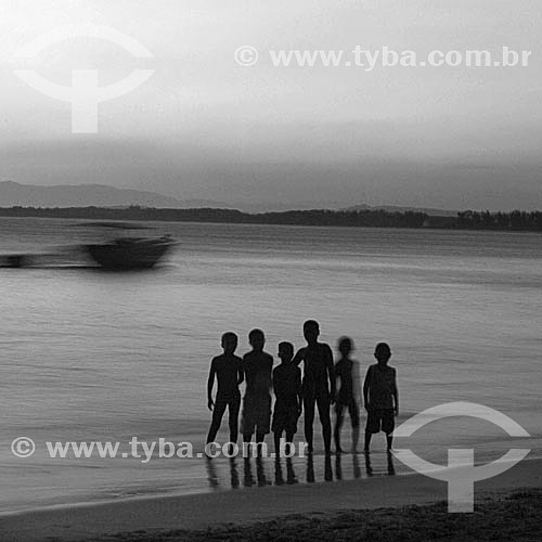  Silhouette of boys walking on the beach - Barra de Guaratiba Beach, at the south coast of Rio de Janeiro city - Rio de Janeiro state - Brazil 