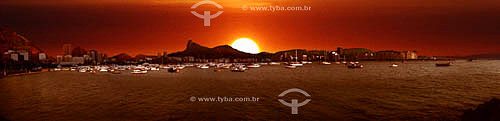  Panoramic view of the Cristo Redentor (Christ the Redeemer) on Corcovado Mountain as seen from Urca at sunset with boats on Guanabara Bay in the foreground - Rio de Janeiro city - Rio de Janeiro state - Brazil 