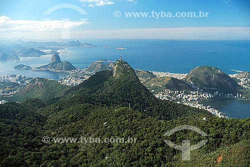  Aerial view of Cristo Redentor (Christ the Redeemer) with Sugar Loaf Mountain* just behind it, and the city of Niteroi in the background - Rio de Janeiro city - Rio de Janeiro state - Brazil  * Commonly called Sugar Loaf Mountain, the entire rock fo 