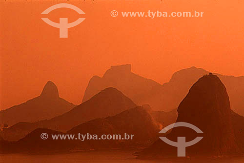  Overview of the mountains of Rio de Janeiro at sunset with Sugar Loaf Mountain (1) in the foreground to the right, and in the background, Morro Dois Irmaos (Two Brothers Mountain) to the left and Rock of Gavea (2) in the center - Rio de Janeiro city 