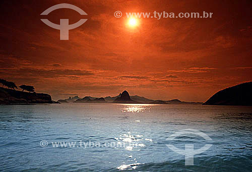  Overview of the mountains of Rio de Janeiro as seen from the sea at sunset with Sugar Loaf Mountain in the very center, Cristo Redentor (Christ the Redeemer) just behind it to the left, and in the background, Morro Dois Irmaos (Two Brothers Mountain 