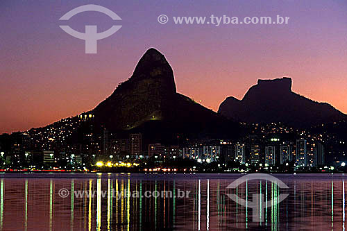  Lagoa Rodrigo de Freitas (Rodrigo de Freitas Lagoon) (1) at sunset, with the lights from buildings reflected on its surface, and the silhouettes of Morro Dois Irmaos (Two Brothers Mountain) and Rock of Gavea (2) in the background - Rio de Janeiro ci 