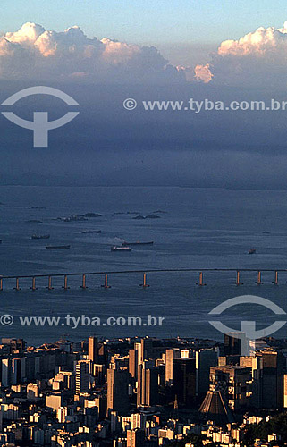  Aerial view of the center of Rio de Janeiro city at sunset, with the Rio-Niteroi Bridge in the background - Rio de Janeiro city - Rio de Janeiro state - Brazil 