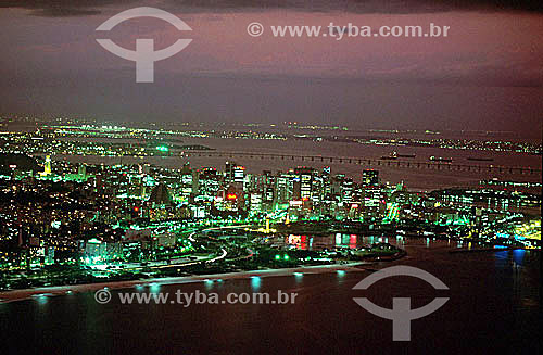  Aerial view of center of Rio de Janeiro city at twilight, with the Rio-Niteroi Bridge in the background - Rio de Janeiro city - Rio de Janeiro state - Brazil 