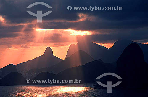  Rays of sunlight break through the clouds above the Rio de Janeiro mountains, with Morro Dois Irmaos (Two Brothers Mountain)* to the left - Rio de Janeiro city - Rio de Janeiro state - Brazil  * National Historic Site since 08-08-1973. 