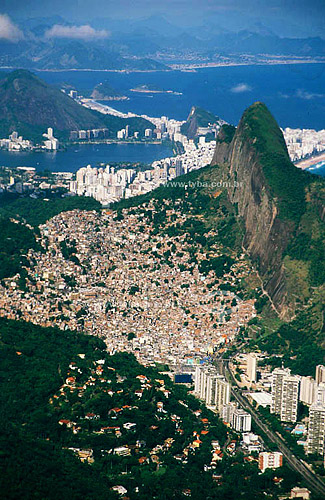  View from the top of the Gavea Rock (1) with the Sao Conrado neighborhood, the Rocinha Slum (2) and the Morro Dois Irmaos (Two Brothers Mountain) (1) in the foreground. Behind: the Lagoa Rodrigo de Freitas (Rodrigo de Freitas Lagoon) (3)  - Rio de J 