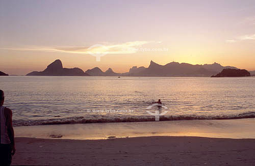  View from Icarai Beach of sunset over Rio de Janeiro showing, from left to right:  the Sugar Loaf Mountain, the Morro dos Dois Irmaos (Two Brothers Mountain), the Rock  of Gavea and the Cristo Redentor (Christ the Redeemer) on Corcovado Mountain - N 