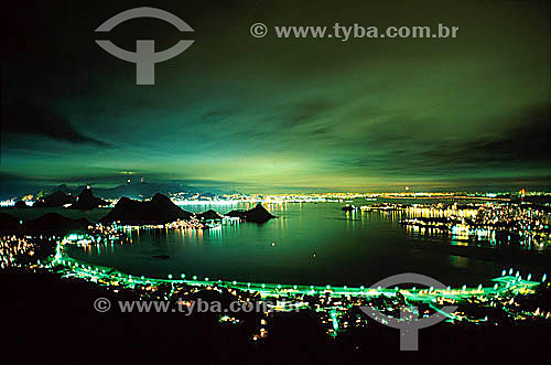  View of lights along the shores of Guanabara Bay at night, with the city lights of Rio de Janeiro in the background reflected on the clouds, at night as seen from Parque da Cidade (City Park) in the city Niteroi - Rio de Janeiro state - Brazil 