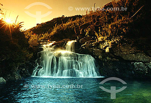  A waterfall at sunset in Itatiaia National Park*, in the south of the state of Rio de Janeiro - Brazil  *This is the oldest National Park in Brazil, created in 1937. It is located among the slopes and peaks of Serra da Mantiqueira, the mountain rang 