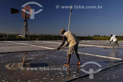  Man working in salt production with a weathercock in the background - Cabo Frio city -  Lakes Region - Rio de Janeiro state north coast - Brazil - February 2005 