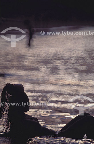  Silhouette of a woman on the beach, highlighted by the reflection of the sun on the water - Búzios city - Costa do Sol (Sun Coast) - Regiao dos Lagos (Lakes Region) - Rio de Janeiro state - Brazil 