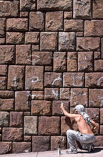  Guy spraying a rock wall 