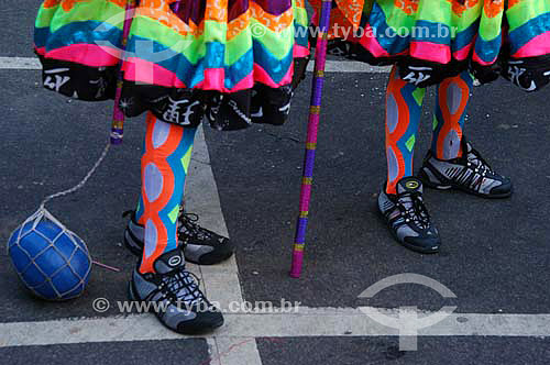  Detail of the legs and feet of revellers dressed up in clovis costume (typical character of the street carnival of Rio de Janeiro) for the Carnival street party - 