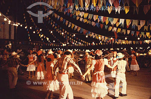  St. John`s Party - People dancing in wheel under typical little flags  
