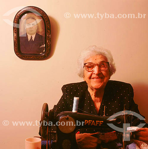  Old woman with a sewing machine 