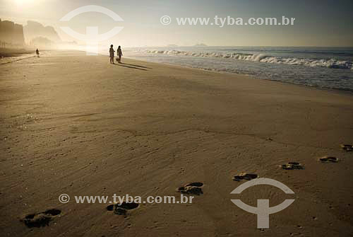  Footprints  and women on Recreio dos Bandeirantes beach with Gavea Stone in the background - Rio de Janeiro city - Rio de Janeiro state - Brazil 