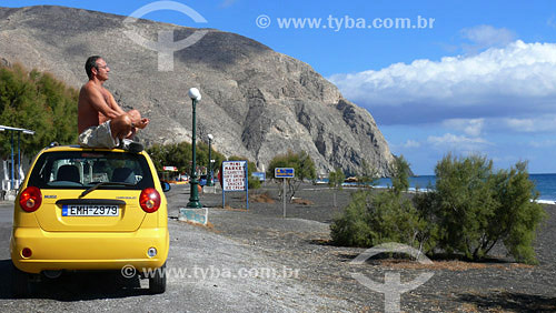  Person sitting in car meditating - Santorini region - Greece 