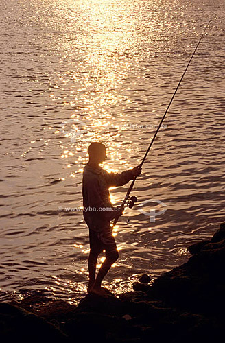  Fisherman with fishing rod at sunrise at Boca da Barra - Cabo Frio city - Rio de Janeiro state - Brazil 